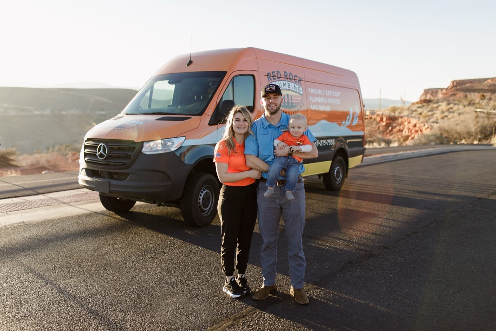 Red Rock Plumbing family with a branded company van